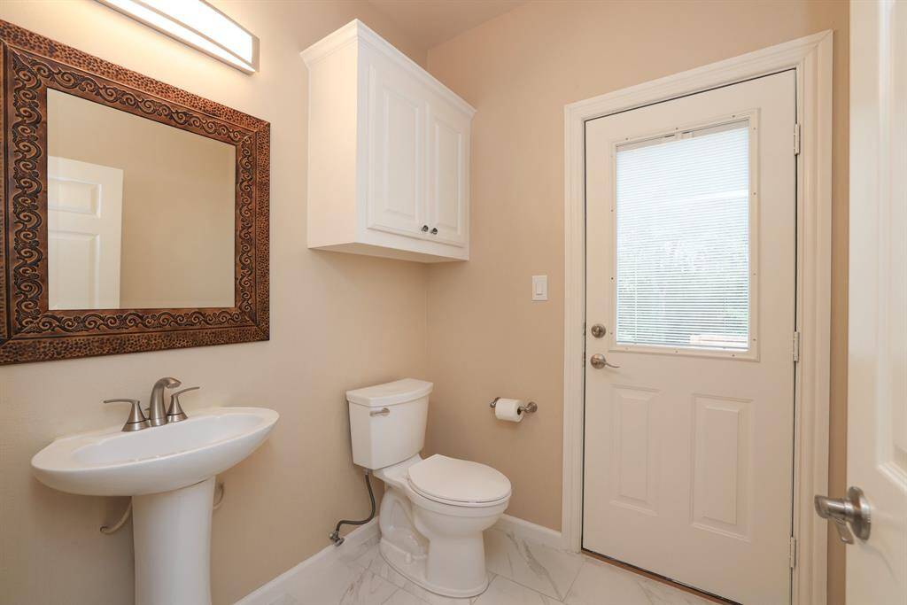 The half bathroom offers convenient direct access to your outdoor living space, perfect for guests and ideal for entertaining, no need to track through the home. A thoughtful feature that enhances both function and flow.