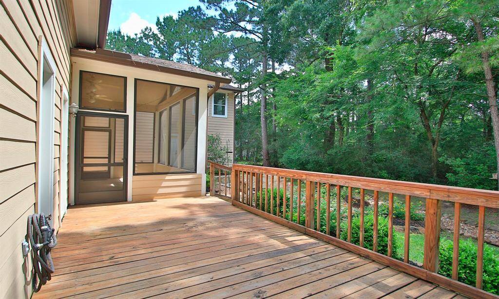 Step out from your seasonal screened-in porch to an extended outdoor living area, ideal for gatherings or quiet evenings.