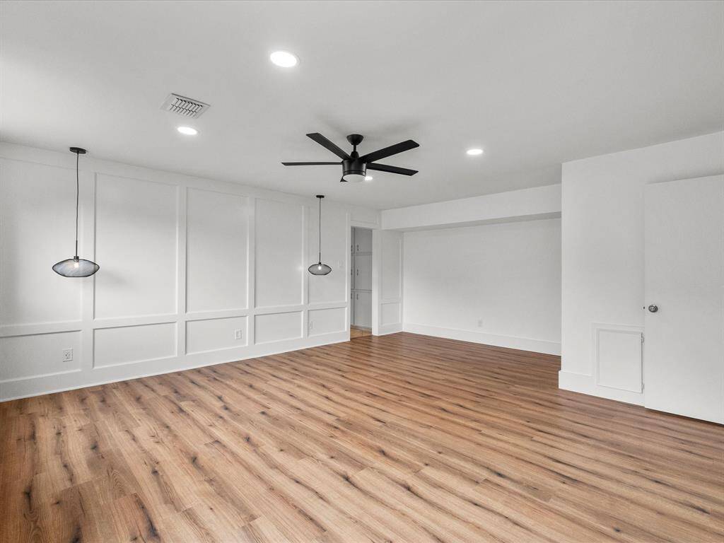 Spacious primary bedroom with modern design and ample natural light.