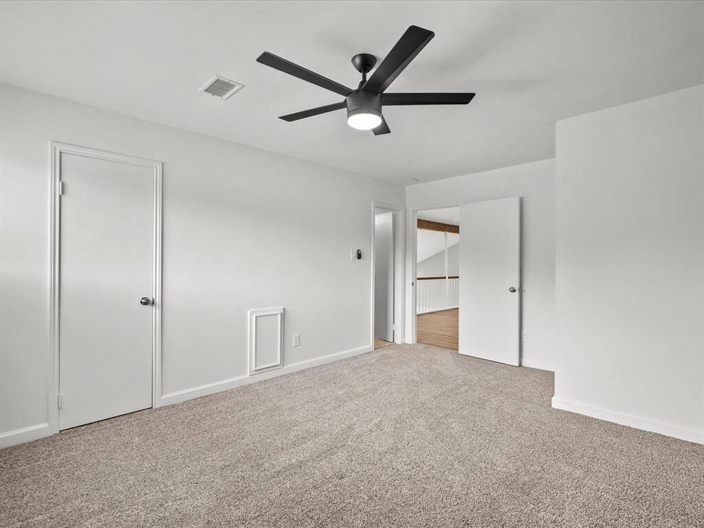 Spacious and versatile upstairs area, perfect for a game room or cozy living space.
