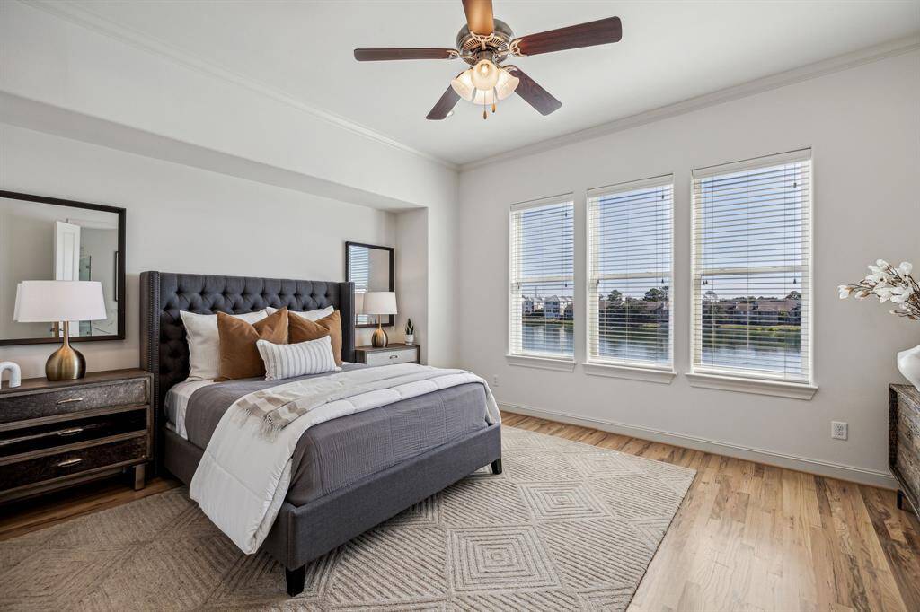 Primary bedroom with wood floors throughout
