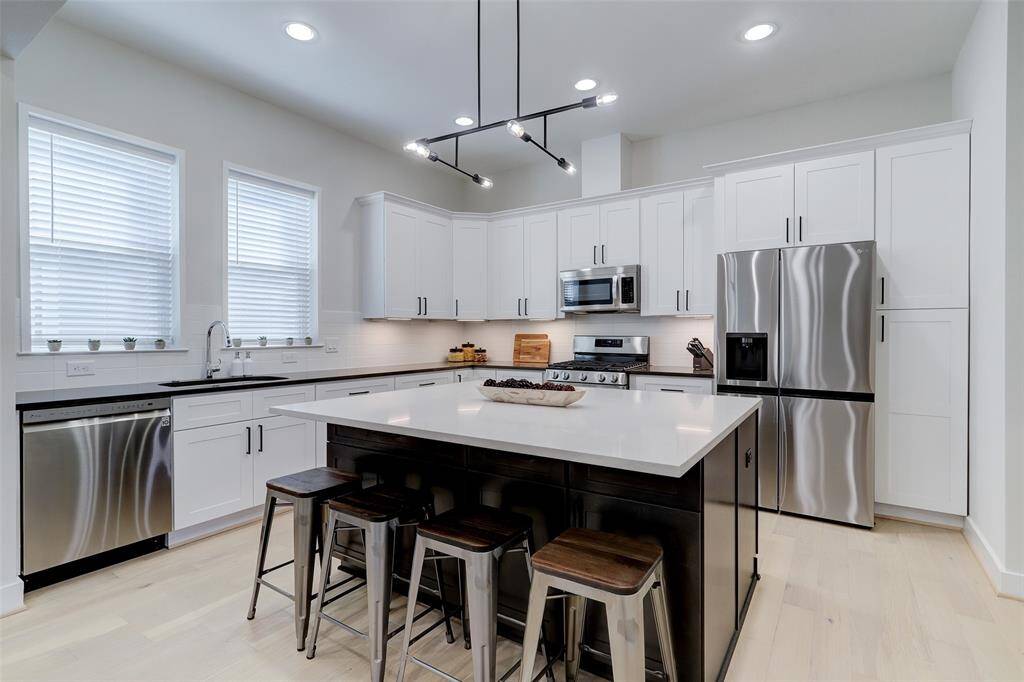 The island features storage on both sides and the breakfast bar will be a favorite for morning coffee
