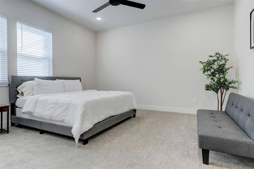 Primary bedroom located on the third floor with carpet.
