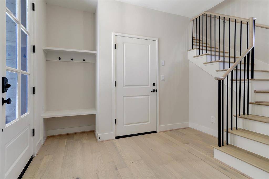 The first floor has access to the attached garage and a bedroom with an en suite bathroom