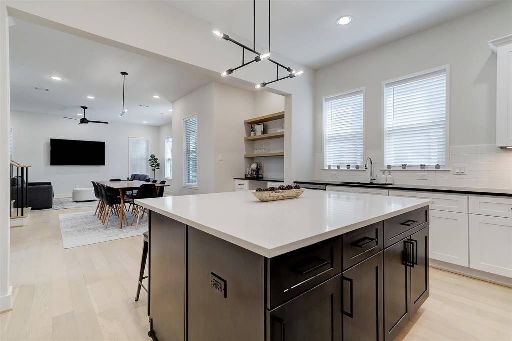Quartz counters on all the surfaces gives a refinement to this modern kitchen.