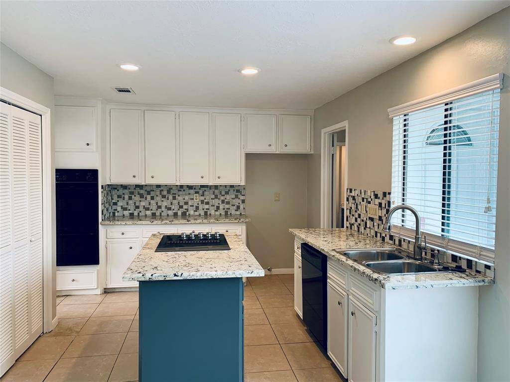 Updated granite countertops, mosaic tile backsplash and painted cabinets!