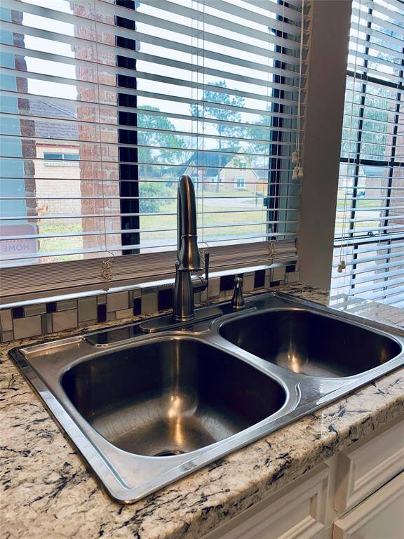 Updated stainless sink and fixtures - overlooking the front of the house!
