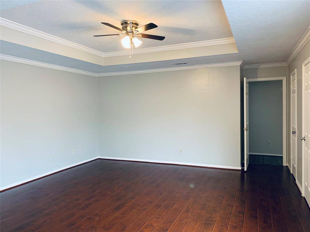 Primary bedroom with wood floors. All hard floors - no carpet in this home.