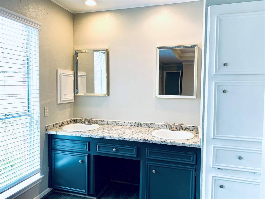 Primary bath vanities have been updated with granite countertop, dual sinks, fixtures, mirrors and paint!
