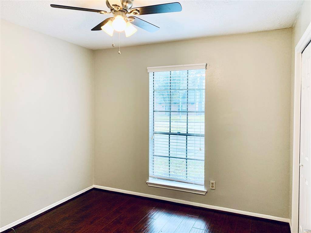 Front secondary bedroom with gleaming wood-look floors and neutral paint!