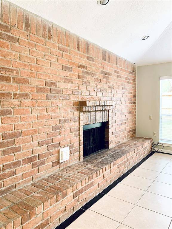 Gorgeous statement brick hearth and fireplace surround with gas fireplace.