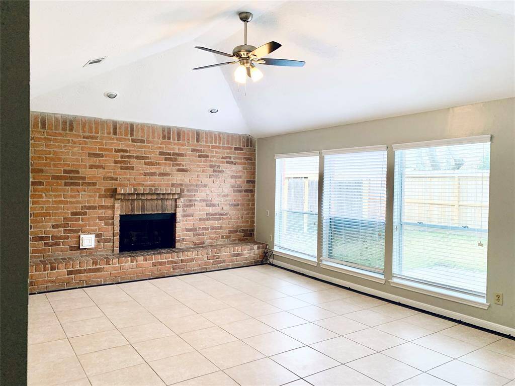 Light and bright living area is very spacious with neutral paint and lighted ceiling fan!