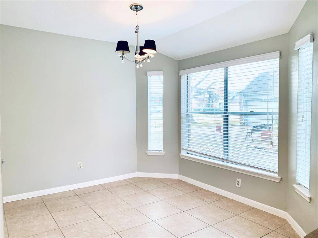 The formal dining room is just off the living area with opening to the kitchen. Also lots of natural light!