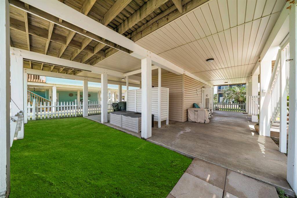 Another portion of the covered patio area, fully fenced for pets & play! Private outdoor shower make beach day cleanup simple.
