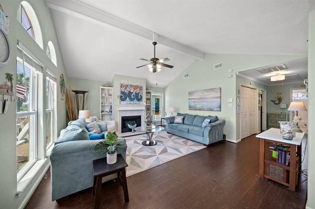 Double doors beyond the living room open to full-size washer & dryer. Primary bedroom suite lies just beyond.