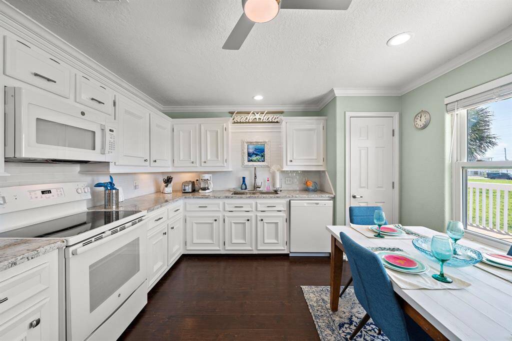 Mermaid Manor's hardwoods gleam against freshly painted cabinets, glass tile backsplash, gorgeous granite counters and new energy-star appliance package.