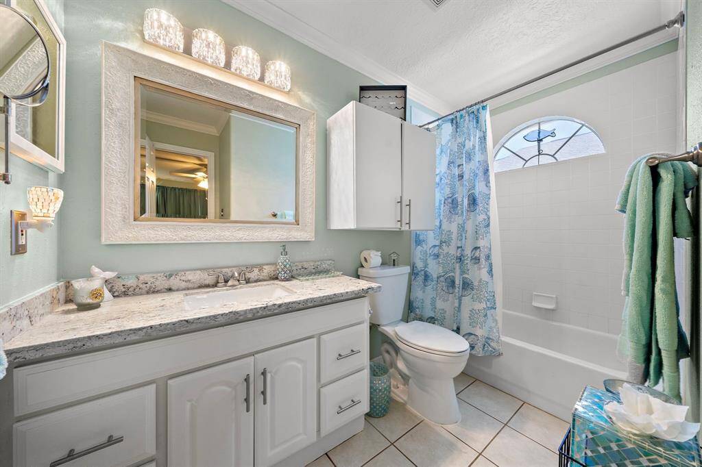 Primary bathroom with gorgeous new granite counters, shimmering fixtures to complement the Gulf