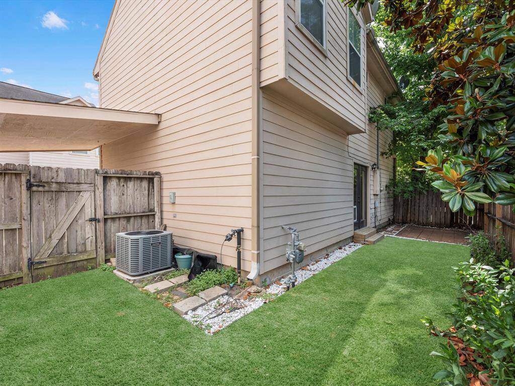 The yard keeps going around the corner. The backside of the one car carport is seen here.
