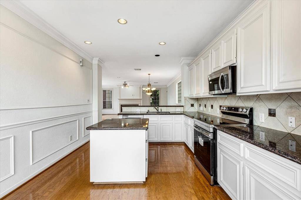 Wide-angle view from the kitchen shows the connection to the main living area, perfect for hosting while staying connected to the action.