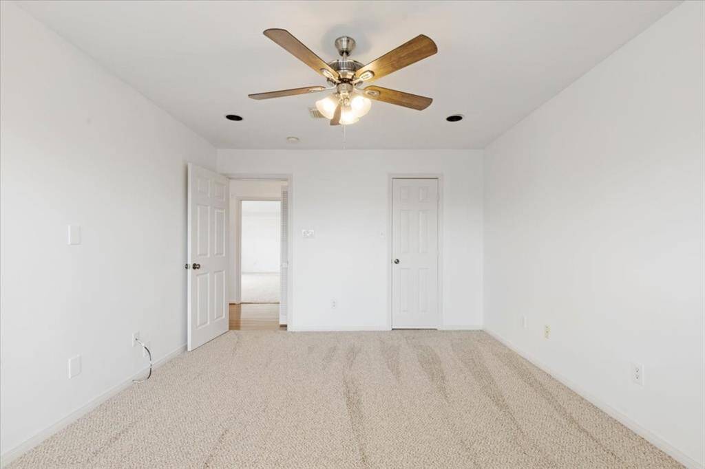 Alternate view of Bedroom 3 shows generous floor space, recessed lighting, and access to a private walk-in closet and full bath.