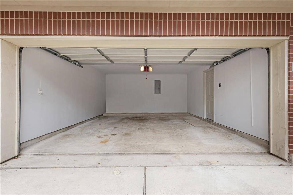 Spacious 2-car garage with clean, freshly painted walls, perfect for parking and additional storage. Offers direct access to the interior of the home.