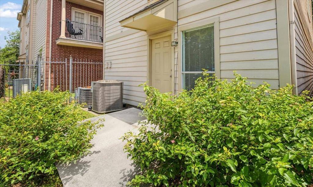 Tucked behind lush greenery, this private patio offers a quiet escape—perfect for morning coffee, container gardening, or winding down after a day in the city. The side entrance adds convenience without sacrificing seclusion.