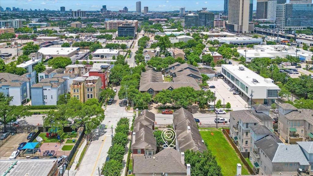 Stunning aerial perspective of the Midtown area, showcasing the home's prime location near restaurants, retail, and Downtown Houston.