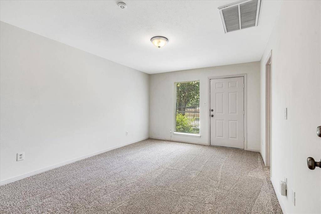 Private downstairs bedroom featuring a walk-in closet, en-suite full bath, and direct access to the gated patio—perfect for guests or a multi-generational living setup.