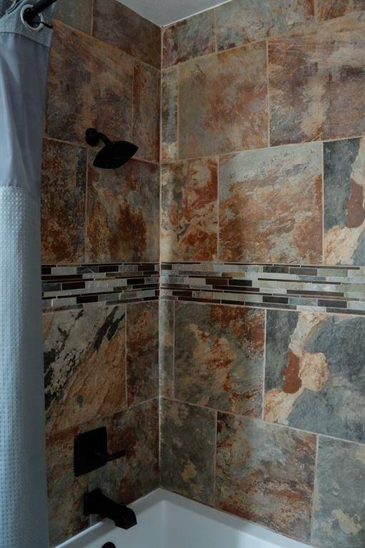Shower tile in hallway bathroom