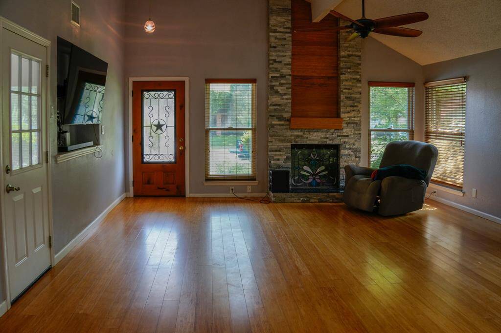 Living room and fireplace with door to garage and front door.