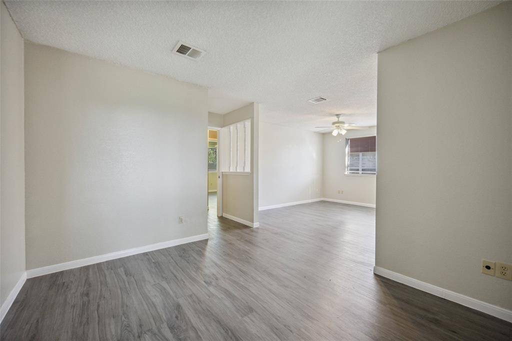 Spacious master bedroom featuring a cozy seating area.
