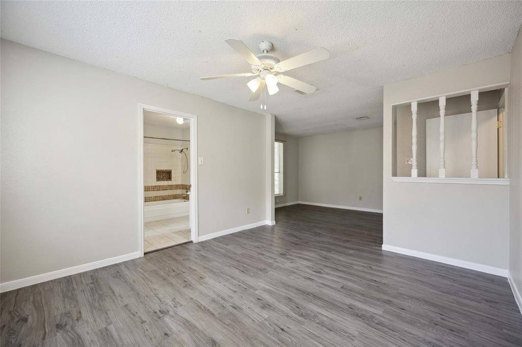 Expansive master suite with modern flooring and abundant natural light.