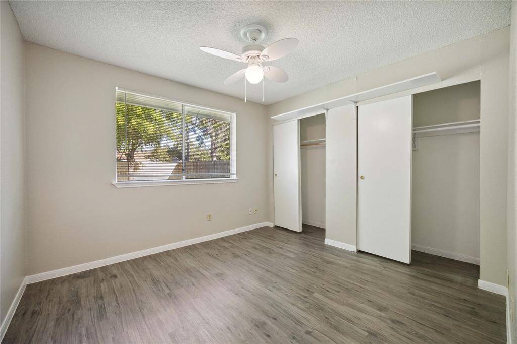 Bright and inviting guest bedroom with ample closet space and serene views.