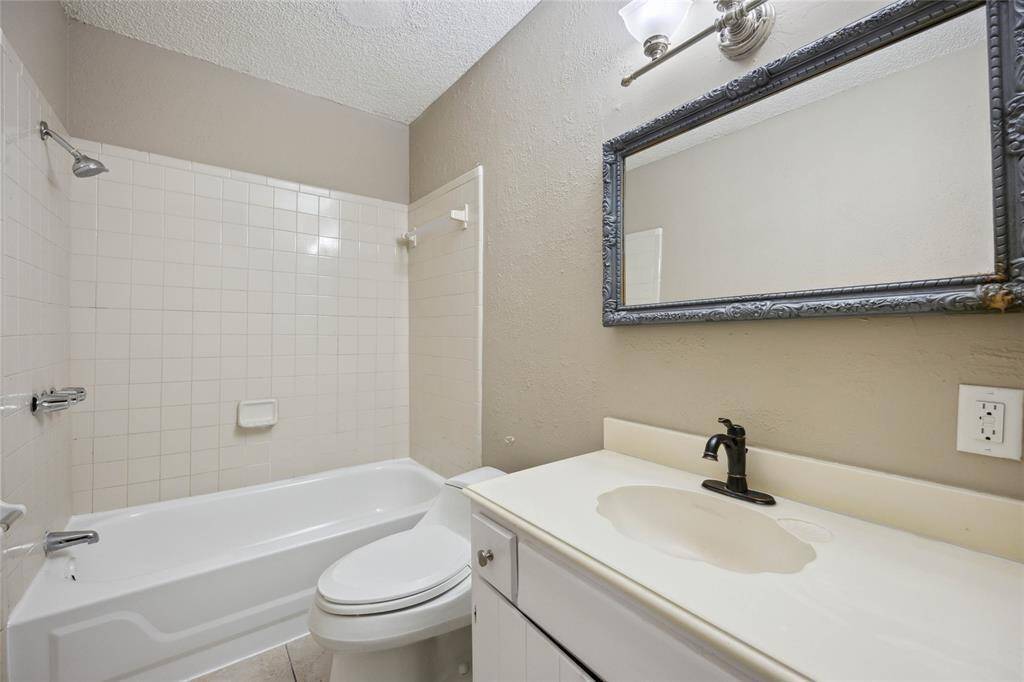 Stylish guest bathroom featuring a sleek shower and modern fixtures.