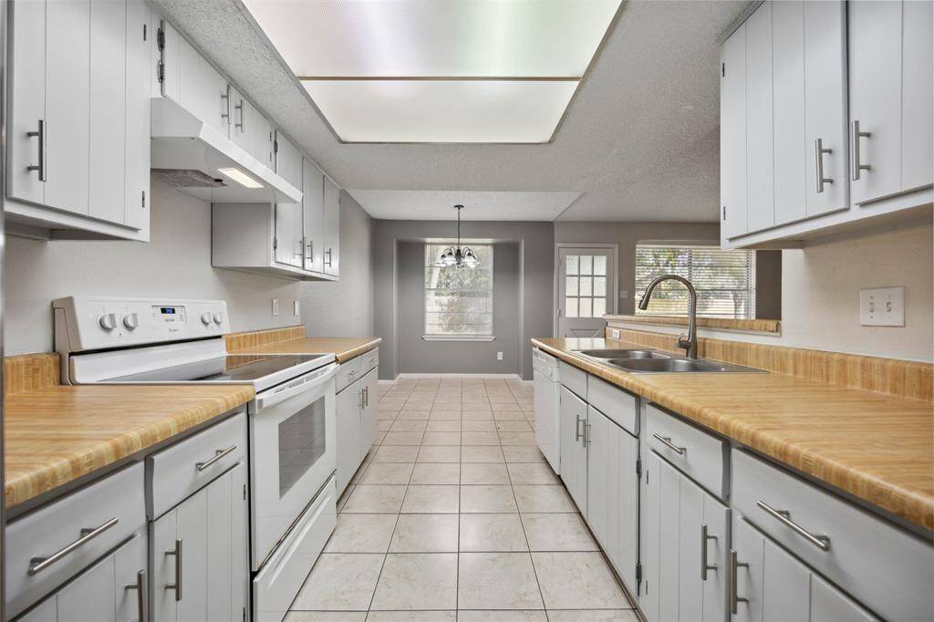 Spacious kitchen with ample cabinetry, and a bright dining nook, perfect for culinary adventures and family gatherings.