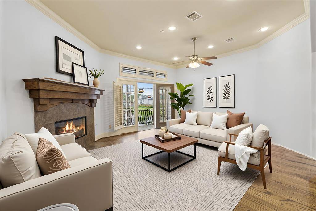 Lounge by the fire in this spacious living room with french doors to balcony facing Commonwealth
