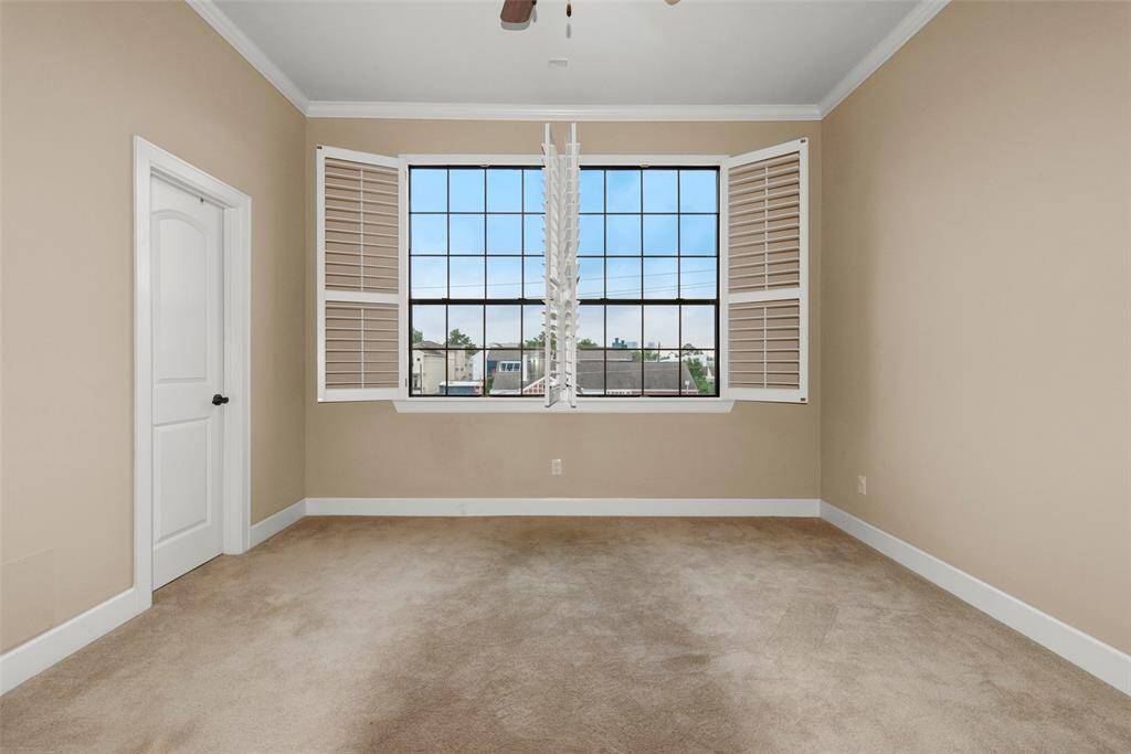Third floor secondary bedroom with shutters open