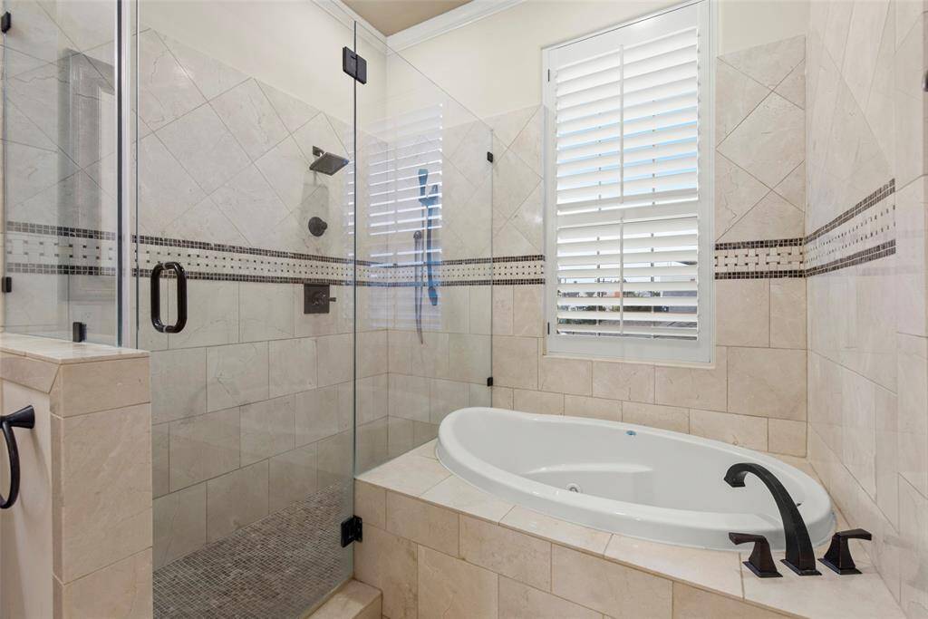 En suite primary bath with jetted tub and walk-in shower