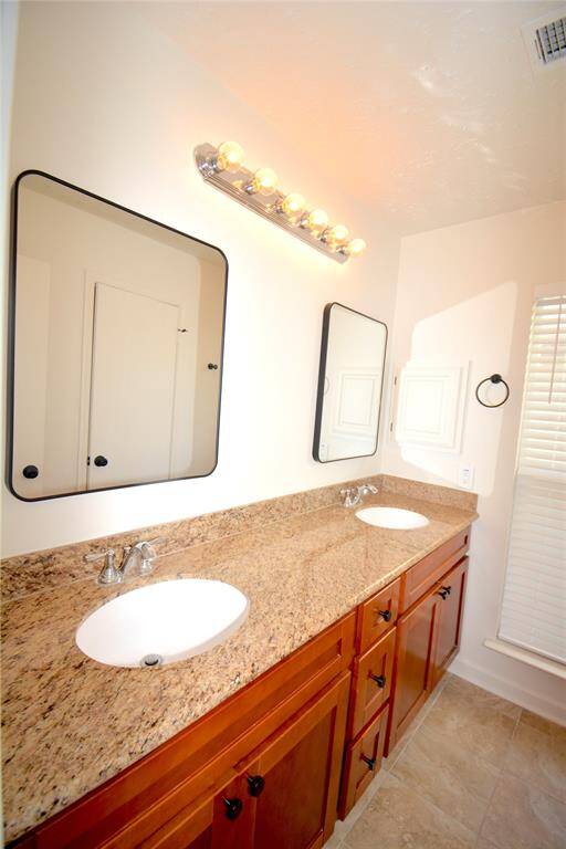 Primary bath with granite counter tops and dual sinks