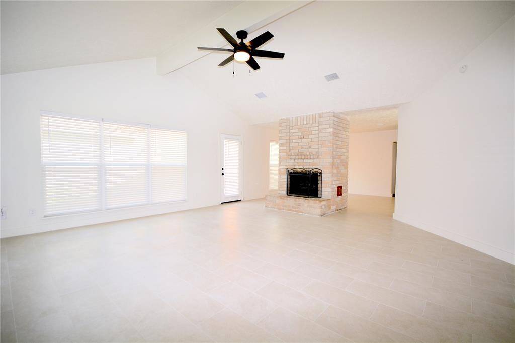 Light and bright family room, soaring ceilings, cozy fireplace and access to the back yard and patio
