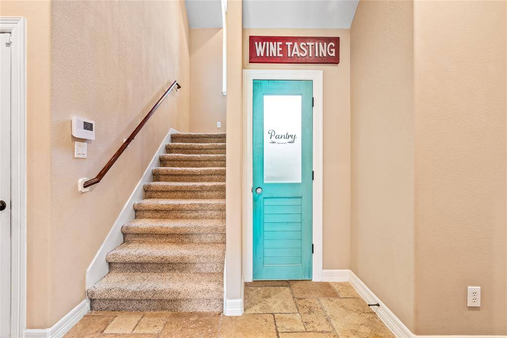 KITCHEN LAYOUT INCLUDES A CONVENIENTLY LOCATED PANTRY AND STAIRCASE ACCESS TUCKED OFF TO THE SIDE.