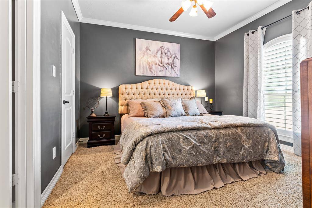 BEDROOM 2 SHOWCASES A PLUSH CARPET, AND PLANTATION SHUTTERS FOR A COZY FEEL.
