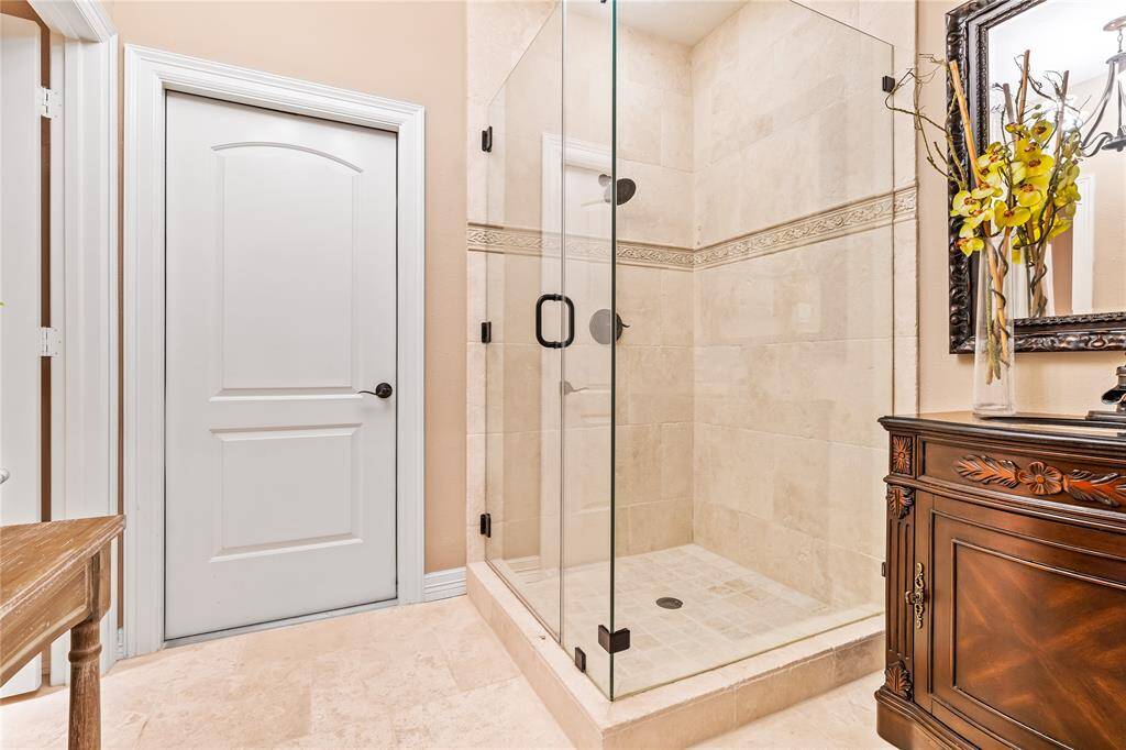 FULL BATHROOM UPSTAIRS WITH ELEGANT TILE WORK AND A FRAMELESS GLASS SHOWER.
