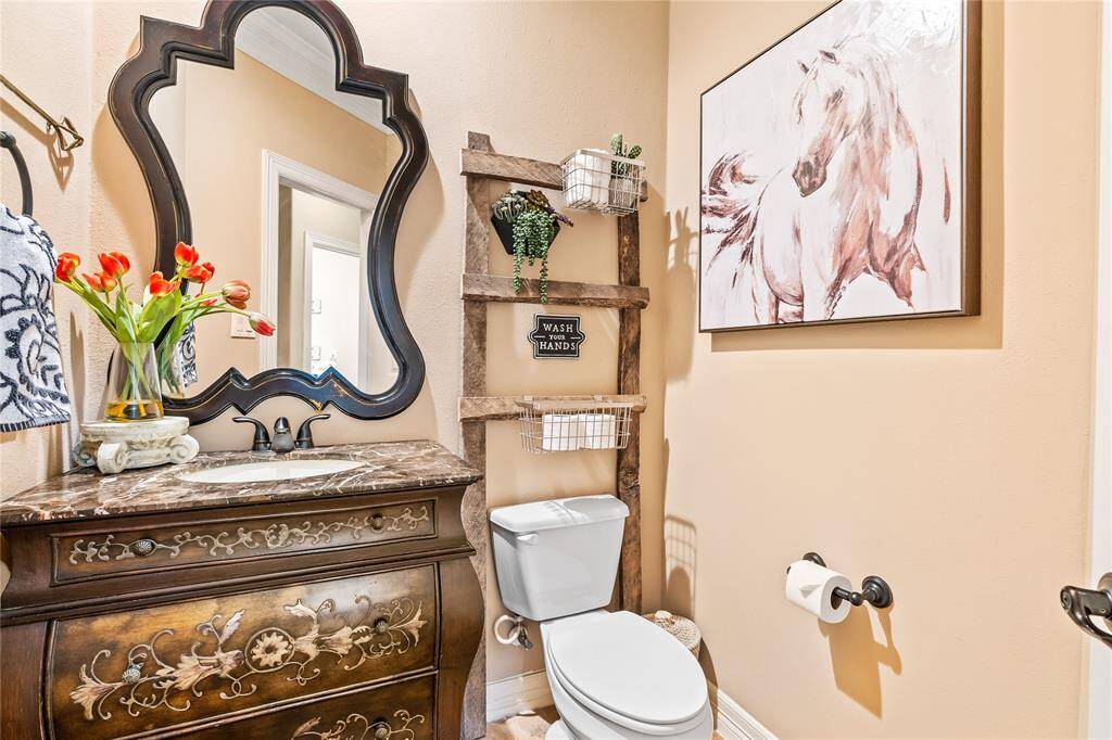 HALF BATHROOM FEATURES A DESIGNER VANITY AND RUSTIC CHIC DECOR.
