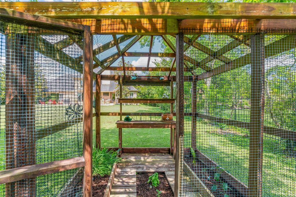 CUSTOM BUILT GARDENING STRUCTURE—READY FOR YOUR HOMEGROWN PRODUCE.