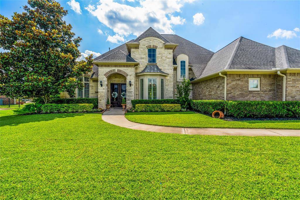 STUNNING STONE AND BRICK FACADE WITH CURVED ENTRY PATH.