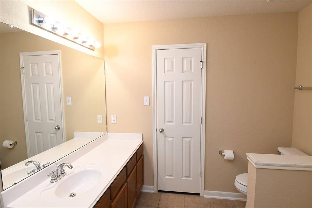 View to large walk-in Master closet behind door at rear.