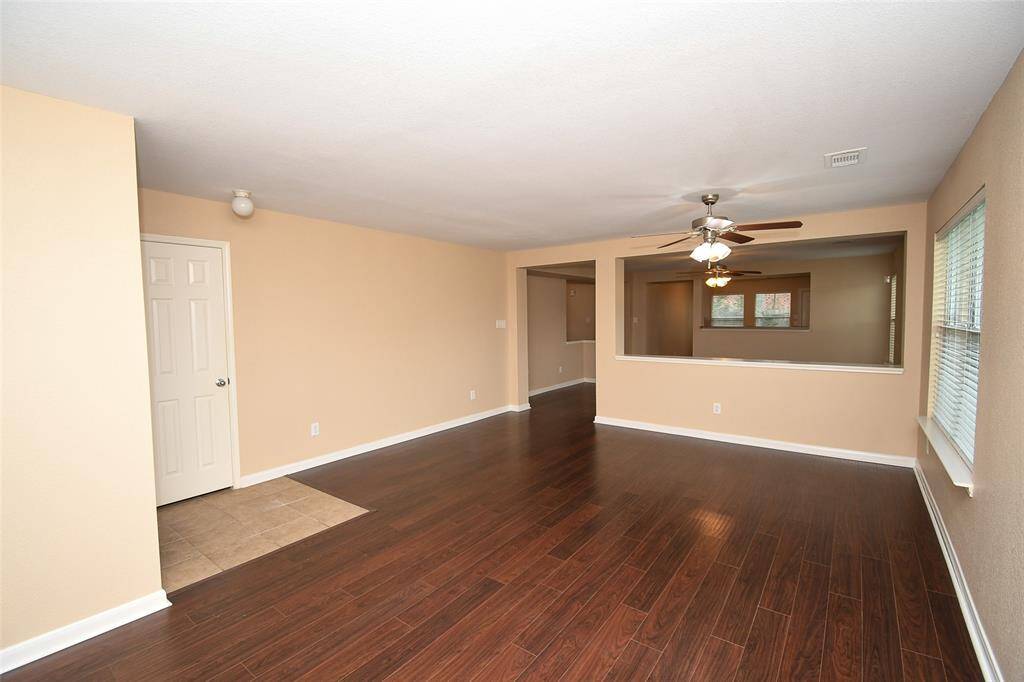 Open view from large Living Room to Dining Room and Kitchen beyond.