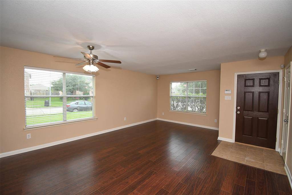 Engineered wood flooring compliments the freshly painted and light filled Living area.
