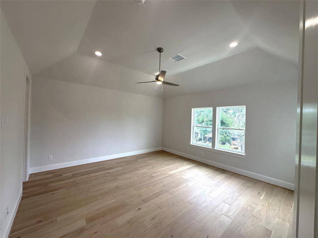 Vaulted Ceilings Primary Bedroom w/ Wide Plank Wood Floors